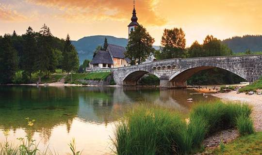 Mountains overlooking lake in SLOVENIA