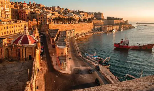 Malta's high brick walls on the edge of the sea